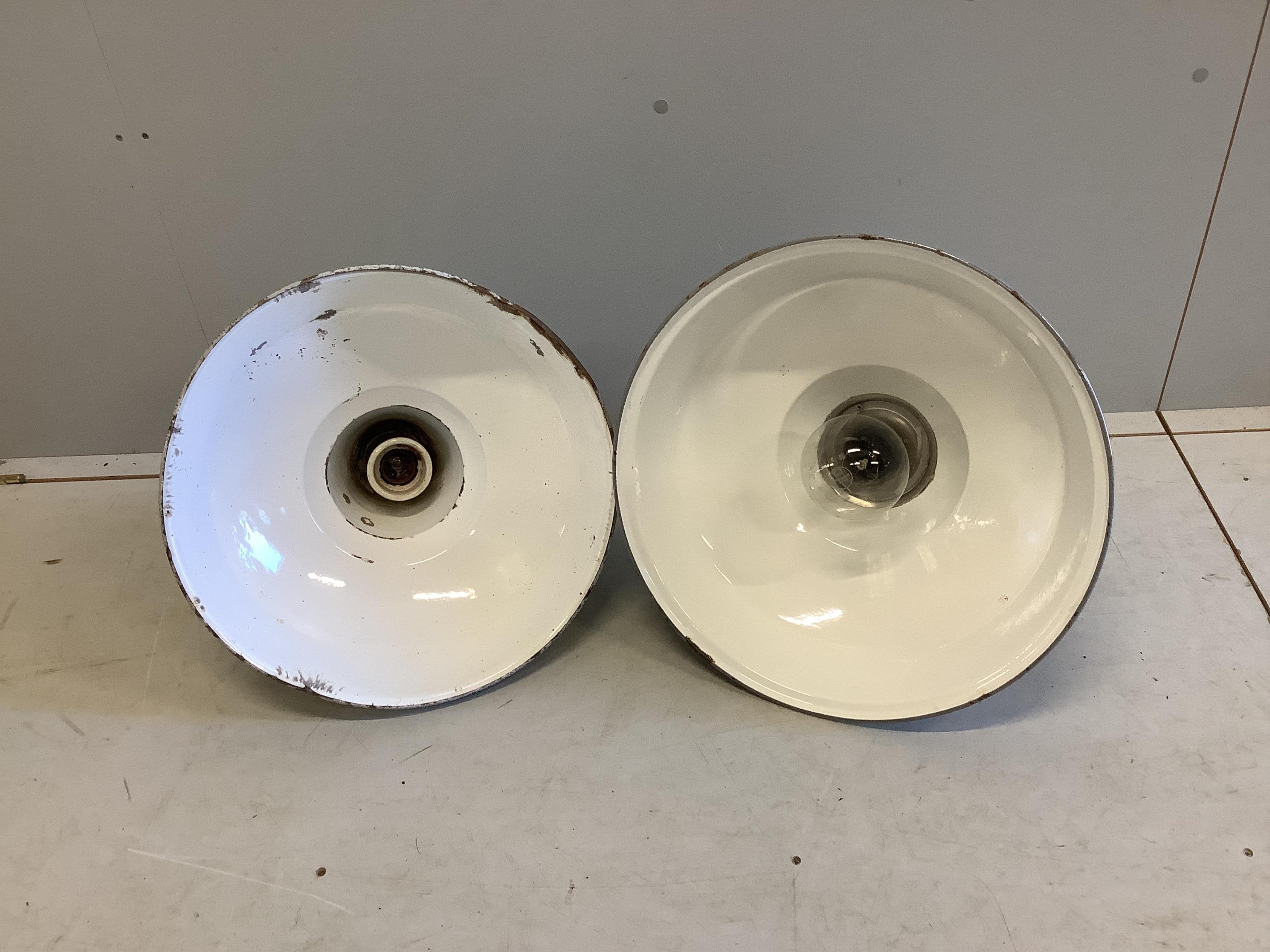 Two vintage Industrial enamelled metal ceiling lamps, larger 48cm diameter, height 38cm. Condition - fair but both have chips to enamel, more severe to the smaller.